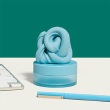 Load image into Gallery viewer, Speks Blur Calming Focus Putty in light blue sitting on a desk
