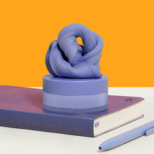 Load image into Gallery viewer, Speks Blur Calming Focus Putty in purple sitting on a desk
