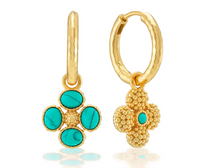 Load image into Gallery viewer, A pair of gold hoop earrings with dangling floral charms. One earring shows a smooth gold hoop and a four-petal flower charm with four round turquoise cabochons and a textured center.
