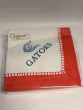 Load image into Gallery viewer, A packaged white paper napkin with a coral-red border, a red stitched border pattern, and blue text reading 'GATORS' alongside a blue bird logo. The brand name 'Caspati' is printed in gold near the lower left corner.
