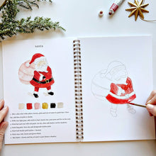 Load image into Gallery viewer, Christmas Watercolor Workbook with person painting Santa 
