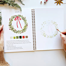 Load image into Gallery viewer, Christmas Watercolor Workbook with person painting a wreath
