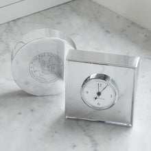 Load image into Gallery viewer, Mariposa Signature Round Clock and square clock, the round clock is turned away from the camera to show the engraved school logo on the solid back of the clock
