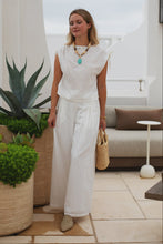 Load image into Gallery viewer, woman in the Hayley Linen Pants in white paired with a white sleeveless top
