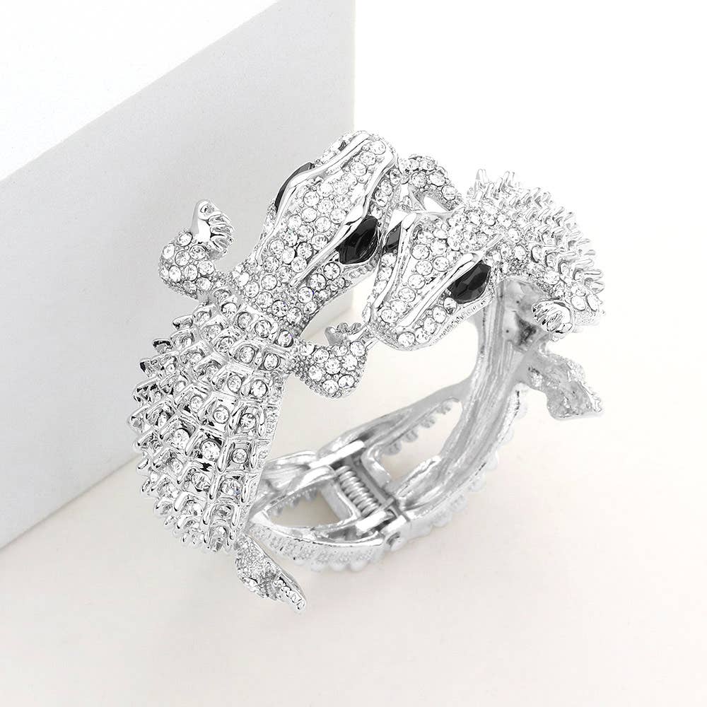 silver bracelet with two gators covered in crystals  