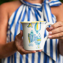 Load image into Gallery viewer, person holding a Vietri Elba's Fish Mug
