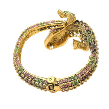 Load image into Gallery viewer, Gold colored Crocodile/Alligator shaped bracelet with many clear pink and green stones showing underside on bracelet and hinge on the tail 

