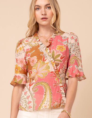 person wearing pink floral print blouse