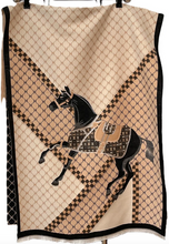 Load image into Gallery viewer, A beige and black patterned scarf featuring a graphic illustration of a rearing horse, hanging against a white background.
