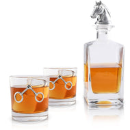 glass decanter with horse head shaped stopper and two glasses with metal horse bit accents