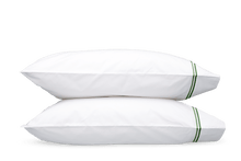 Load image into Gallery viewer, Two pillows with Matouk Essex pillowcases with two simple lines of embroidery in green, one line a slightly lighter shade than the other
