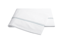 Load image into Gallery viewer, Matouk Essex flat sheet with two simple lines of embroidery in pool blue, one line a slightly lighter shade than the other
