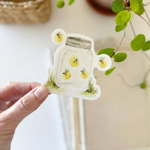 hand holding a watercolor-style Fireflies in a glass jar Sticker 