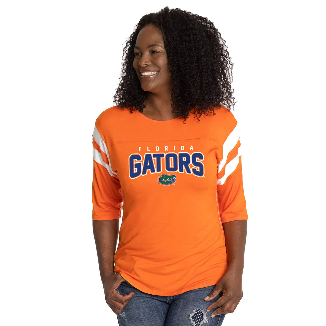 woman wearing an orange shirt with white stripes on the sleeves  and Florida Gators text on the front