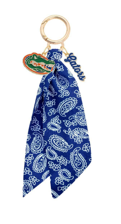 charm with three accents, a Gator logo, gators written in blue script, and blue and white fabric tie