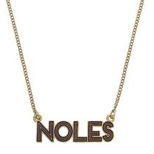 Load image into Gallery viewer, Close up of pendant on a gold necklace - Pendant reads NOLES with maroon and black enamel 
