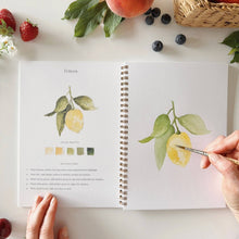 Load image into Gallery viewer, person paining a lemon in the Fruit Watercolor Workbook
