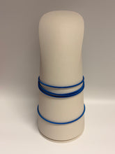 Load image into Gallery viewer, Beige cylindrical object with blue bands on a beige background
