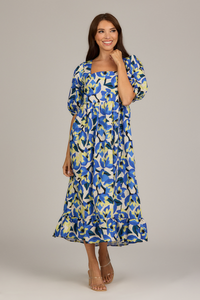 woman in long blue light yellow and white floral dress with puff sleeves