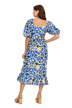 Load image into Gallery viewer, woman in long blue light yellow and white floral dress with puff sleeves and square neckline
