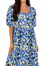 Load image into Gallery viewer, woman in long blue light yellow and white floral dress with puff sleeves and square neckline
