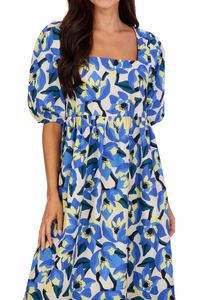 woman in long blue light yellow and white floral dress with puff sleeves and square neckline