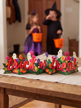 Load image into Gallery viewer, Ghostly Greetings Accordion Card on a table for decoration 
