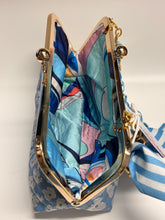 Load image into Gallery viewer, Floral-patterned handbag with gold frame and striped bow on a white background
