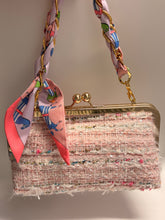 Load image into Gallery viewer, Pink textured handbag with a colorful scarf draped over it on a neutral background

