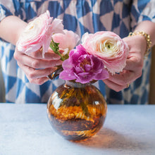 Load image into Gallery viewer, person putting flowers in the Vietri Hibiscus Glass Brown Tortoiseshell Bud Vase
