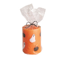 Load image into Gallery viewer, Orange pillar candle with pumpkin and ghost designs
