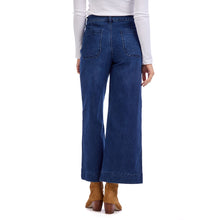 Load image into Gallery viewer, person wearing Jake Wide Leg Pants, wide leg blue jeans with white shirt and brown boots, back view showing pocket stitching  
