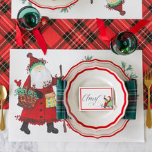 Load image into Gallery viewer, Hester &amp; Cook Old St. Nick Forest Placemat  on a red plaid holiday table
