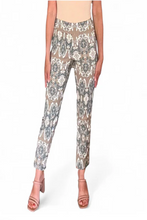 Load image into Gallery viewer, Floral patterned pants worn by a person on a white background
