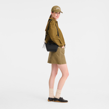Load image into Gallery viewer, person holding a Longchamp Le Pliage Energy X-Small Top Handle Bag in in black
