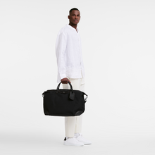 Load image into Gallery viewer, person holding a Longchamp Boxford Travel Bag Large - Black
