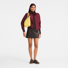 Load image into Gallery viewer, person holding the Longchamp Le Pliage One L Top handle Bag Handbag under her shoulder
