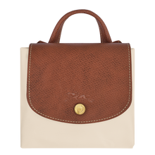 Load image into Gallery viewer, Folded Longchamp Le Pliage Lid Medium Original Backpack in the color Paper with brown leather accents 
