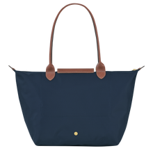 Load image into Gallery viewer, Longchamp Le Pliage Original Large Shoulder Tote Bag in the color navy with brown leather handles and flap and gold hardware back of the purse with the gold snap near the bottom center of the back
