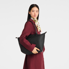 Load image into Gallery viewer, person holding the Longchamp Le Pliage One L Shoulder Bag Handbag in black under her shoulder
