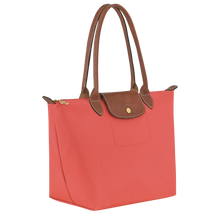 Load image into Gallery viewer, Longchamp Le Pliage Original Medium Shoulder Bag in a pink strawberry color with brown leather handles, center flap and gold hardware 
