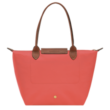 Load image into Gallery viewer, Longchamp Le Pliage Original Medium Shoulder Bag in a pink strawberry color with brown leather handles, center flap and gold hardware back view showing stitching
