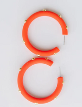 Load image into Gallery viewer, Bright orange hoop earrings with small gold studs, shown on a plain light gray background.
