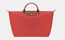 Load image into Gallery viewer, Longchamp Le Pliage Original Large Luggage Travel Bag in orange/red with brown leather trimming
