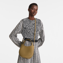 Load image into Gallery viewer, person with the Longchamp Le Foulonné Leather Top Handle Handbag in the color caper worn across the shoulders
