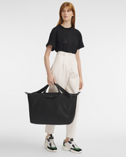 Load image into Gallery viewer, person holding Longchamp Le Pliage Xtra Travel Bag - Large - Black

