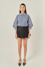 Load image into Gallery viewer, person in the Striped Balloon Sleeve Shirt paired with a short black skirt
