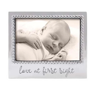 silver color frame with LOVE AT FIRST SIGHT engraved in a script font

