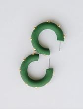Load image into Gallery viewer, Green crescent-shaped hoop earrings with small gold studs, displayed on a clean white background.

