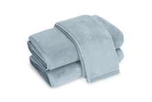 Load image into Gallery viewer, Stack of two light blue bath towels and a hand towel
